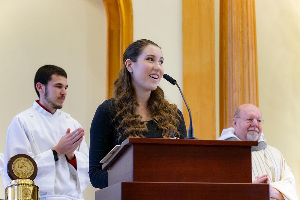 student standing at front of chapel